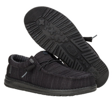 Load image into Gallery viewer, Black sneakers with a focus on the sole design on a white background