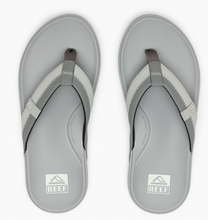 Load image into Gallery viewer, Pair of gray sandals with Reef logo on a white background