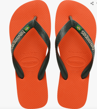 Load image into Gallery viewer, Havaianas brand flip-flops, a pair of vibrant orange textured soles with dark grey straps featuring white embossed Havaianas lettering and a small Brazilian flag emblem