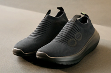 Load image into Gallery viewer, Pair of gray slip-on shoes on a neutral background