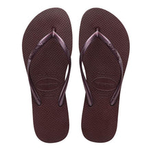 Load image into Gallery viewer, Product image of a pair of dark brown Havaianas flip-flops with shiny metallic purple textured straps, featuring the Havaianas logo embossed on both the straps and soles