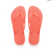Load image into Gallery viewer, Photography of a pair of vibrant coral Havaianas flip-flops featuring a textured rubber sole