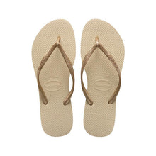 Load image into Gallery viewer, A pair of Havaianas flip-flops with beige textured soles, shiny rose gold braided straps featuring the brand name, and visible size 37-38 detail on a white background