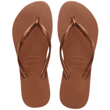 Load image into Gallery viewer, Havaianas product photography a pair of shiny metallic rose gold flip-flops featuring a textured rice grain sole and the brand logo embossed on the straps and heel