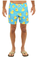 Load image into Gallery viewer, Blue swim shorts with yellow rubber duck pattern worn by a person on a white background
