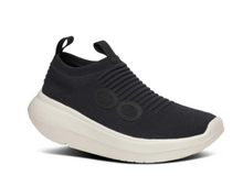 Load image into Gallery viewer, A chalk black colored women's active recovery shoe with a seamless knit upper and a flat sole featuring circular elements on the side.
