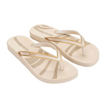 Load image into Gallery viewer, A pair of beige Ipanema flip-flops with metallic gold straps, displayed on a clean white background.
