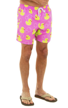 Load image into Gallery viewer, Pink swim shorts with yellow rubber duck pattern worn by a person on a white background
