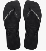 Load image into Gallery viewer, Pair of black flip-flops with a brand logo on a white background
