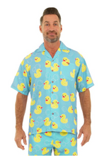 Load image into Gallery viewer, Man wearing a blue pajama set with yellow rubber duck pattern on a white background
